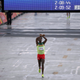 Feyisa Lilesa makes the controversial crossed fists sign as he finishes in second place.